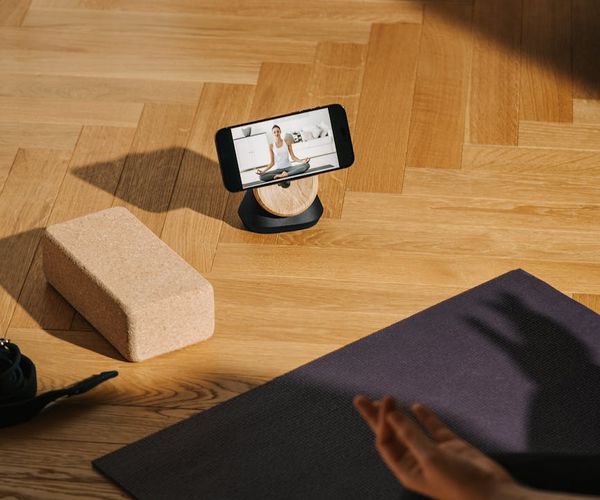 Bright and spacious yoga studio with large windows and wooden floor.