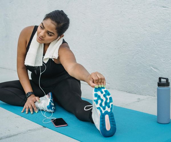 Yoga mat, water bottle, and a small towel neatly arranged.